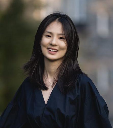 Photo of Jane Wang smiling at the camera, in a black dress